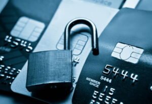 An opened padlock on top of a credit card to represent a credit card data breach.