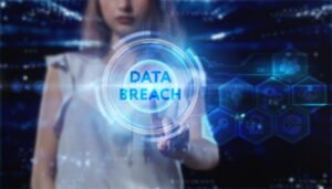 A woman touching a digital display of the words 'data breach' in blue.