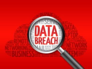 A word cloud on a red background with the words data breach magnified. 
