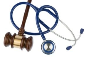 Gavel and stethoscope on a white background.