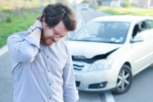 A man wondering how long does it take to settle a whiplash claim