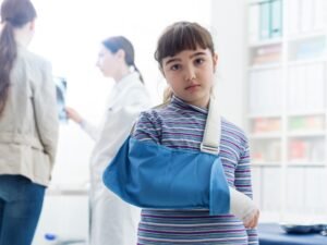A child with an arm in a sling. 