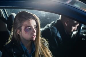 Physically and mentally injured passenger next to an unconscious driver.