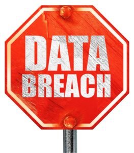 The words 'data breach' written on a red stop sign with a plain white background.