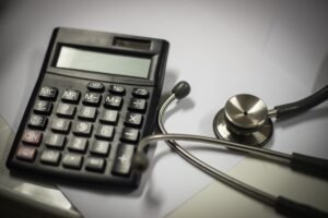 A calculator next to a stethoscope to represent medical negligence compensation.