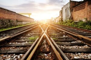 A close-up image of train tracks at sunrise.