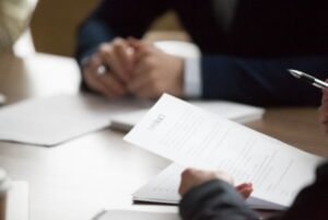 A personal injury solicitor and client review a contract agreement for a bulging disc at work claim