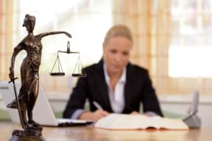 A dog bite claim solicitor sitting at a desk and writing in a book.