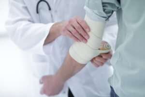 A medical practitioner provides care to a patient.