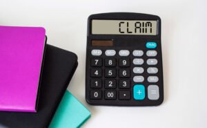 A calculator with the word 'claim' on the screen
