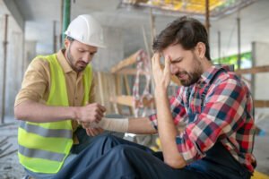 Man with wrist and arm injuries from accident at work.