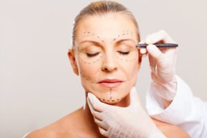 Woman preparing for cosmetic surgery on face with a medical professional