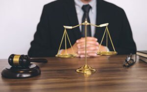 A solicitor behind a desk discusses accident at work how long to claim with a client