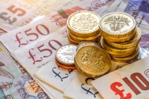 A pile of prison injury compensation in bank notes and coins. 