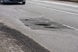 A large pothole on a road.