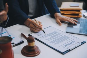 A motorway accident claim solicitor signing a contract