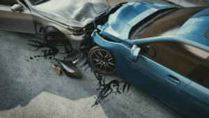 A pair of cars (one grey, one blue) whose distracted drivers collided head-on. 