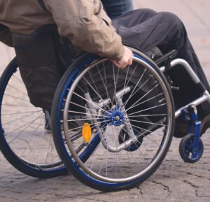 A paralysed person uses a wheelchair.