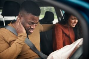 A couple in a car collision both suffering from whiplash after an accident that was not their fault.