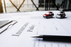 An image shows an insurance policy, on a desk, to be completed. 