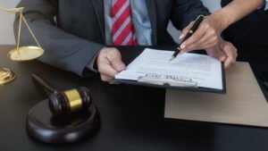 Personal injury lawyers examining a contract with a judge' gavel and justice scales