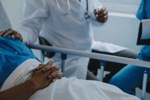 A nurse helps a care patient put compression stockings on to prevent a blood clot DVT.