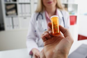 lady doctor giving prescribed pills to a patient in hospital