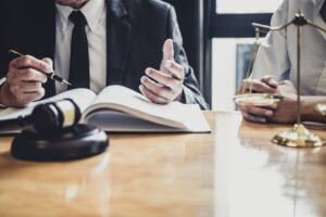 Two specialist medical negligence solicitors take notes at a desk while working on a No Win No Fee claim