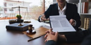 Clinical negligence solicitor explains court proceedings at a table with scales and a gavel.