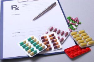 Medication on a table with a clipboard and pen