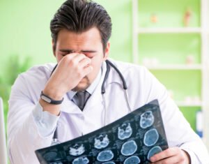 A healthcare professional looks disappointed at test results