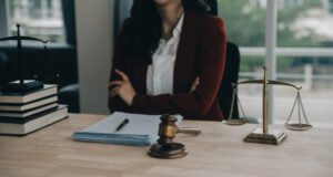 A solicitor working on an ophthalmology negligence claim seated behind a table with gavel and justice scales