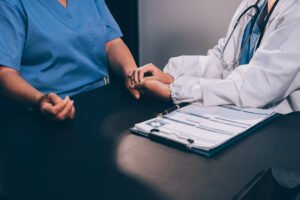 Medical professionals sitting next to each other in an office