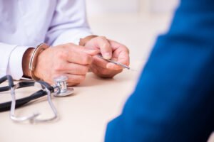 A negligent doctor with a patient at a desk.