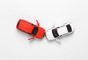Two toy cars in a front on collision representing a car crash