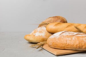 Loaves of bread on a chopping board that could pose a risk to someone with wheat intolerance