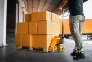 A delivery driver unloads packing boxes.