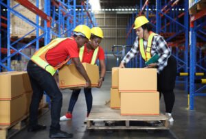 Workers load a pallet for delivery.