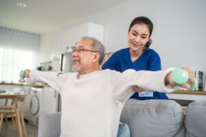 A nurse helping a care home resident exercise