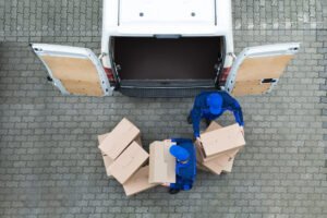 Delivery drivers unload a van.