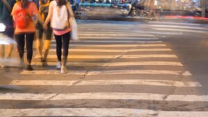 Blurry people using a zebra crossing. 