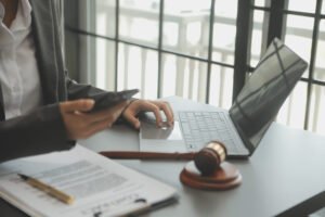 A solicitor working on burn injury compensation claims on their laptop
