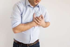 A man holds his chest after an injury
