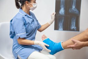 A healthcare professional examining the X-rays of her patient's broken foot