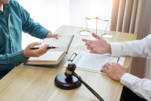A solicitor discussing a claim with their client who was injured due to a lack of work safety boots
