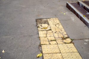 Broken paving slabs at the foot of some steps